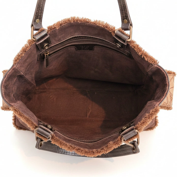 Close-up of a brown leather handbag with visible wear and tear.
