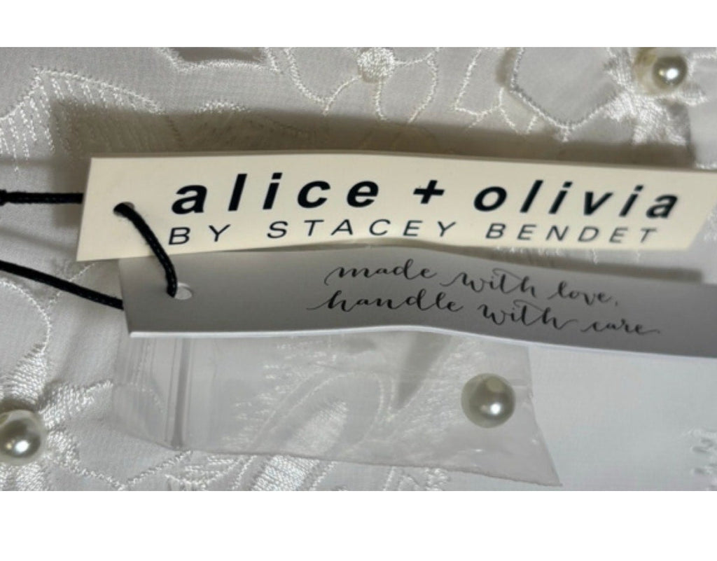Alice + Olivia by Stacey Bendet tag on a garment with a white background