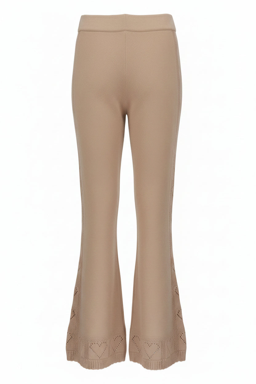 Beige pants with heart patterned cuffs on a white background