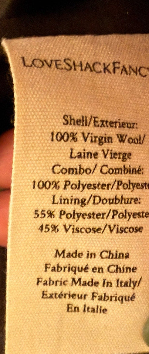 Close-up of a label on a garment with 'LOVESHACKFANCY' branding.