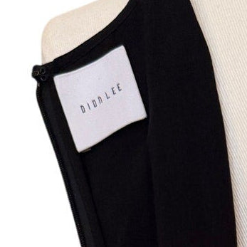 Black sleeveless top on a mannequin with a white background