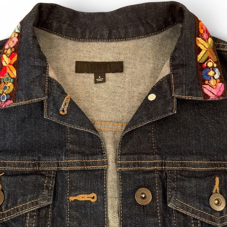 Denim jacket with floral embroidery on a white background