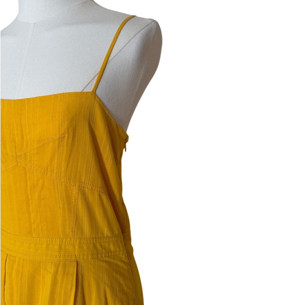 Yellow dress on a mannequin against a white background
