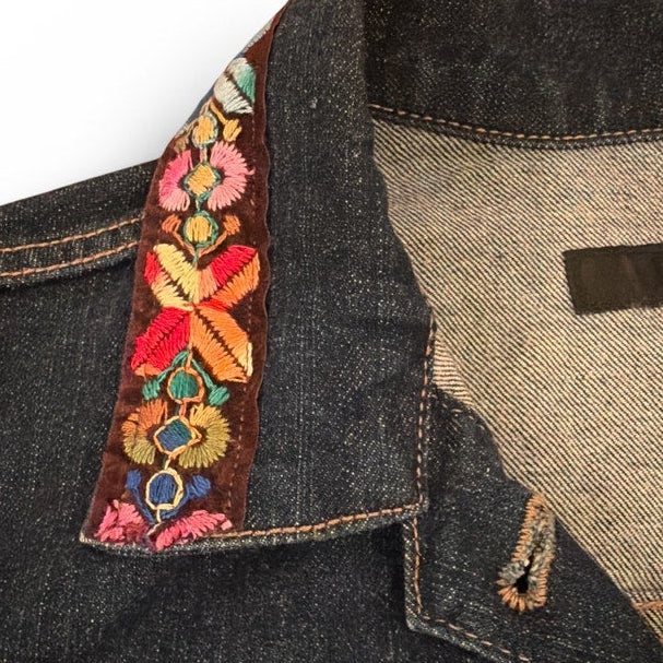 Denim jacket with colorful floral embroidery on a white background