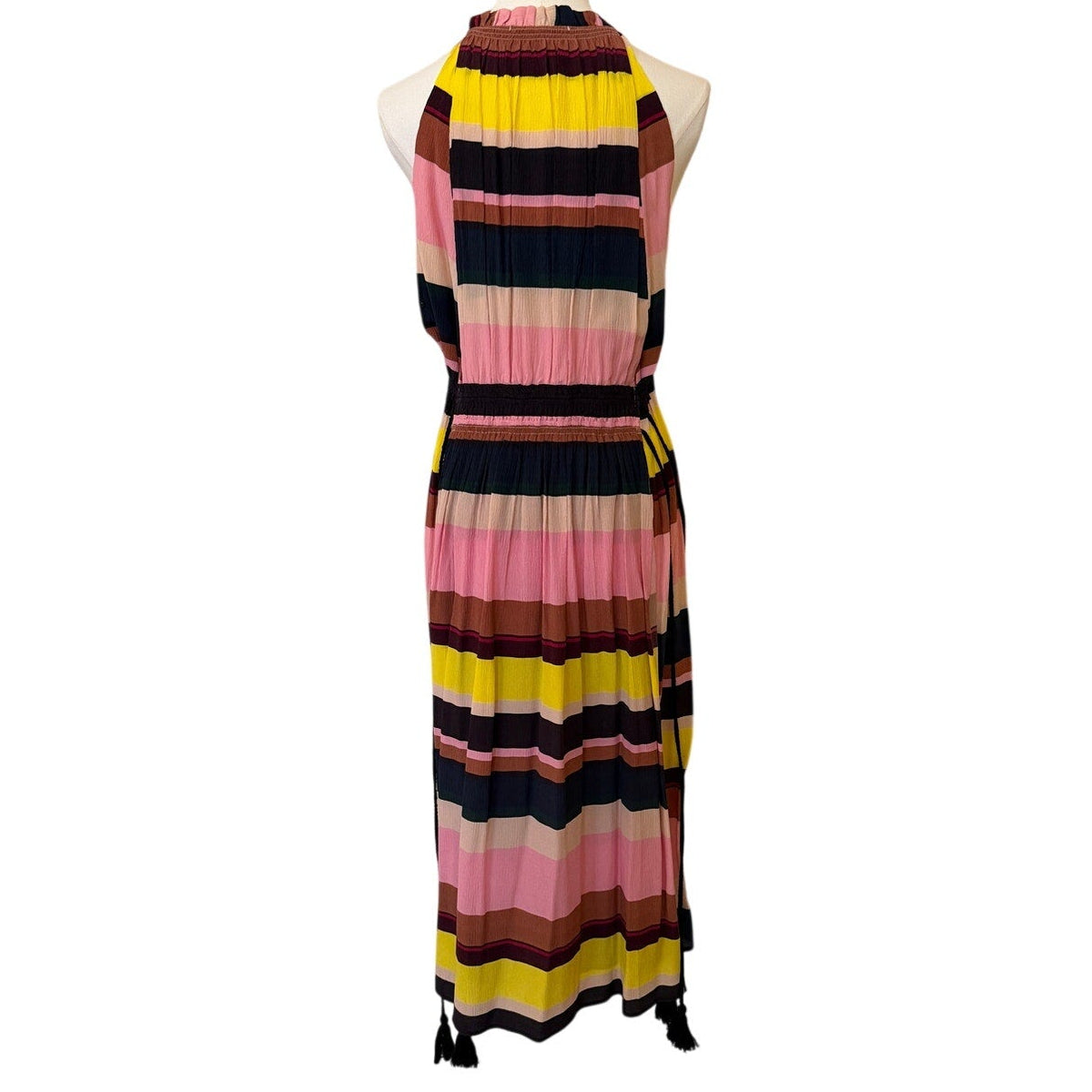 Colorful striped dress on a mannequin against a white background