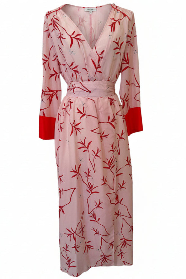 A long-sleeve midi wrap dress with a red bamboo leaf print on a light pink background, featuring solid red cuffs and a matching waist tie, shown against a plain white background.