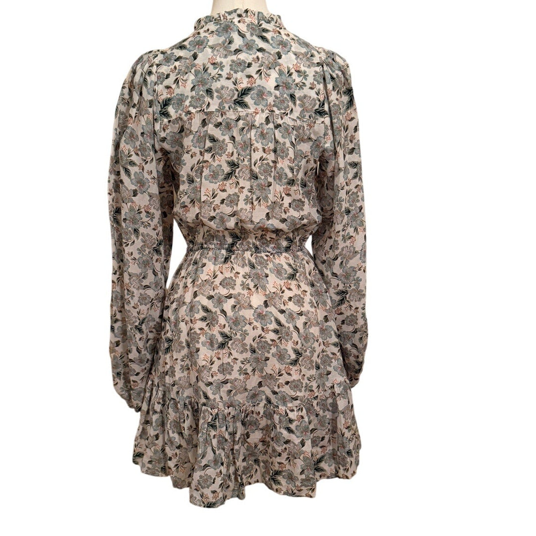 Floral dress on a mannequin against a white background