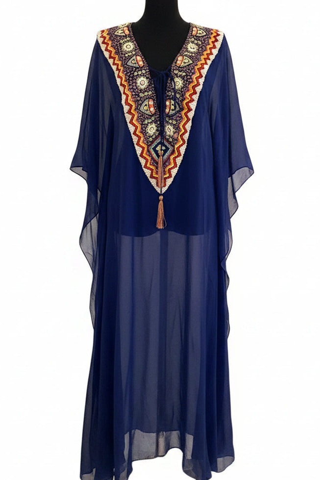 Blue dress with intricate orange and yellow embroidery on a mannequin against a white background