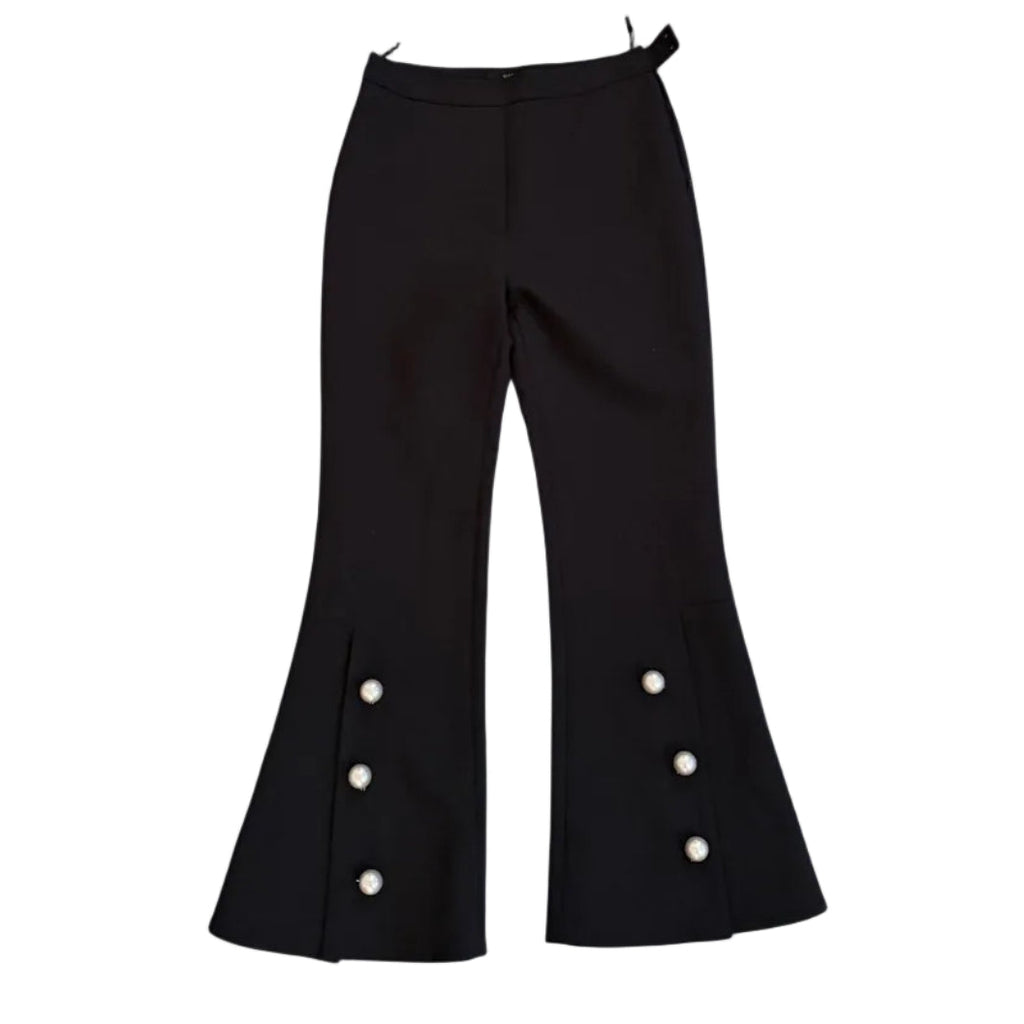 Black bell-bottom pants with white buttons on a white background