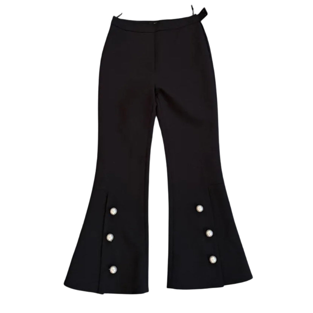 Black bell-bottom pants with white buttons on a white background
