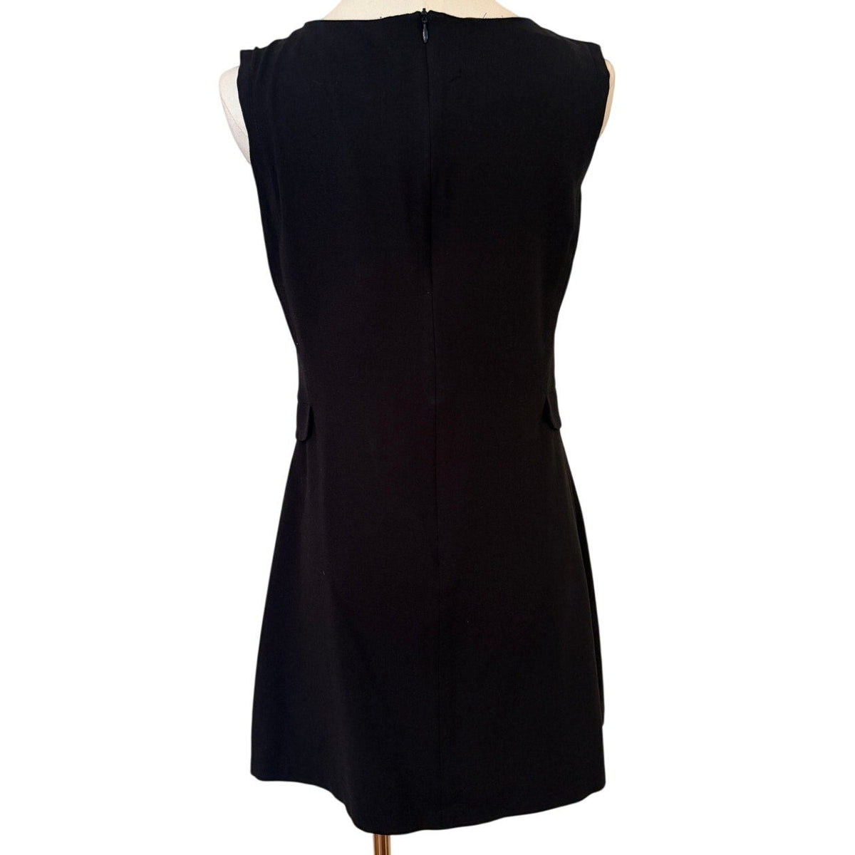 Black dress on a mannequin against a white background