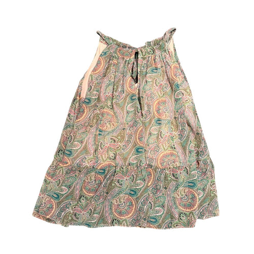 A sleeveless tiered dress with a multicolor paisley pattern in green, pink, orange, and beige, featuring a tie-neck detail, shown against a plain white background.