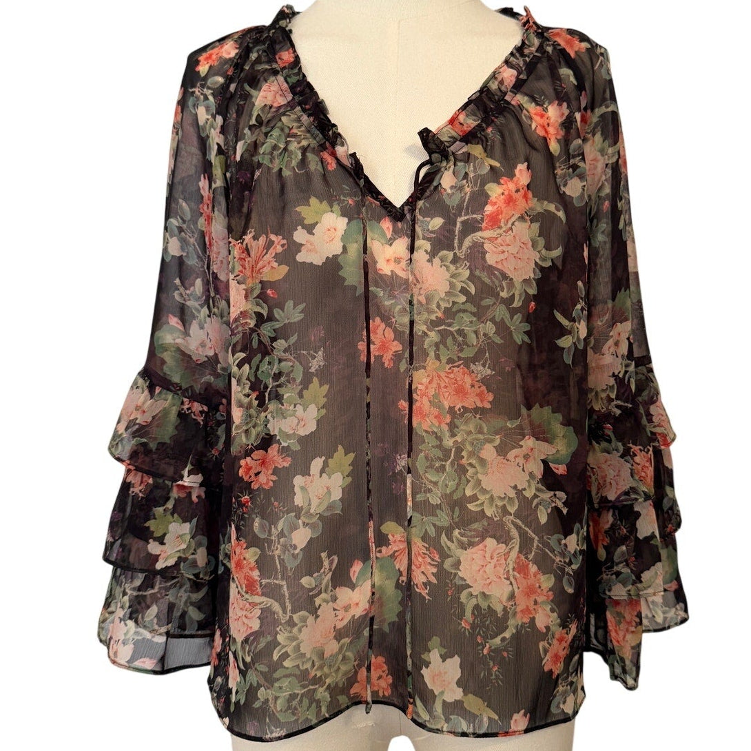Floral blouse on a mannequin against a white background