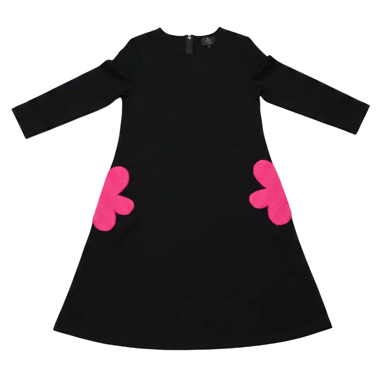 Black long-sleeve top with pink hearts on a wooden floor
