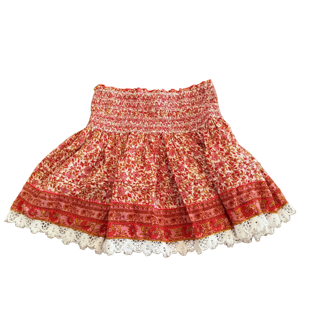 Red patterned skirt with white lace hem on a wooden floor