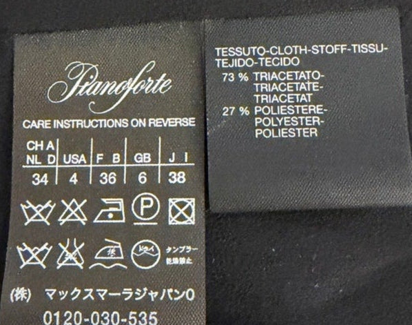Black fabric with two labels on a white background