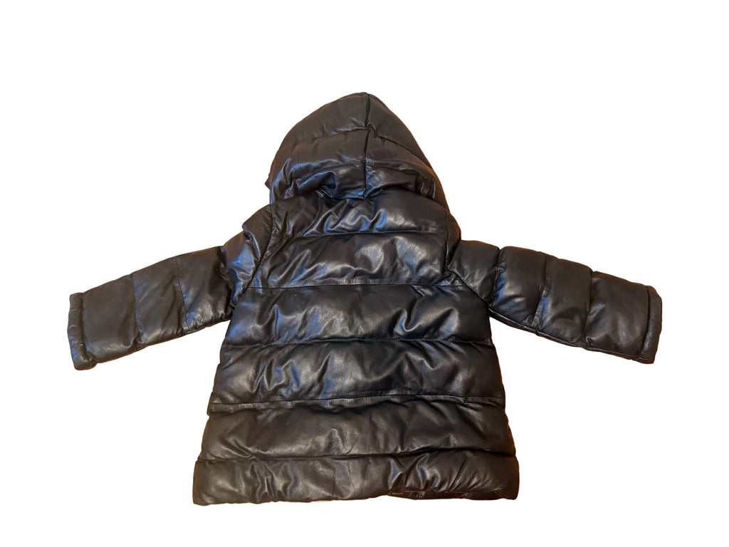 Bailey Grace Closet Concierge black lambskin leather puffer jacket with a hood, laid flat on a wooden floor.