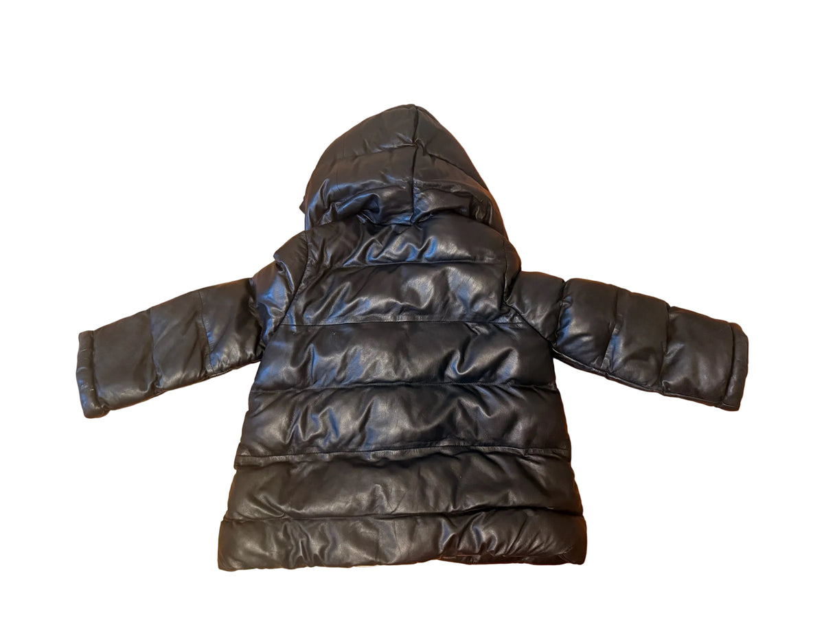 Bailey Grace Closet Concierge black lambskin leather puffer jacket with a hood, laid flat on a wooden floor.