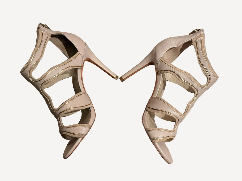 Bailey Grace Closet Concierge nude stiletto sandals with wavy cut-out straps and metallic piping detail.
