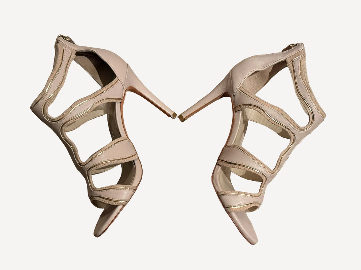 Bailey Grace Closet Concierge nude stiletto sandals with wavy cut-out straps and metallic piping detail.