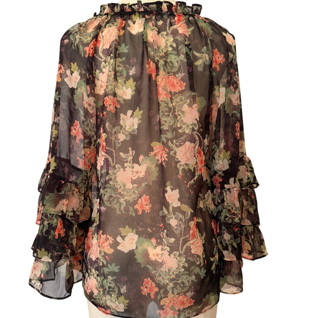 Floral blouse on a mannequin against a white background
