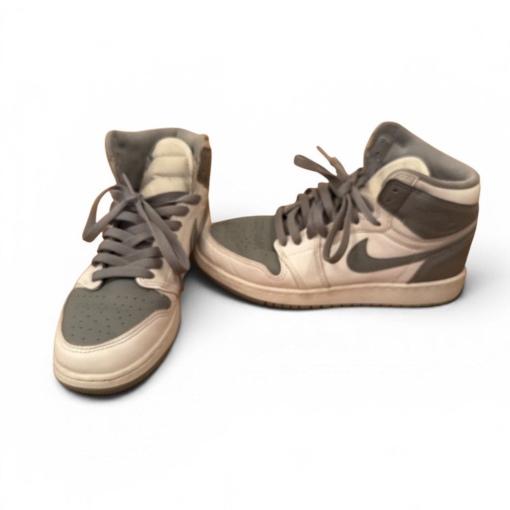 Pair of brown and beige sneakers on a white background